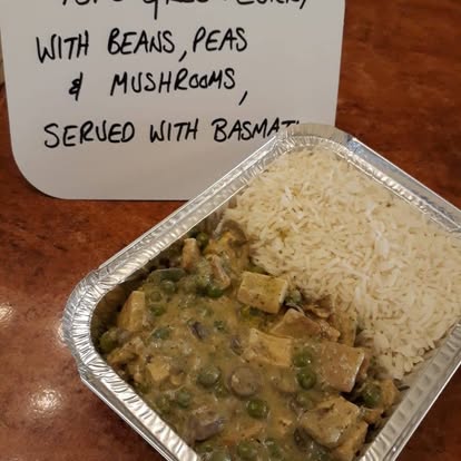 Tofu green curry with beans & peas, served with basmati rice